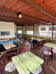 a dining room with tables and chairs and windows at Pousada Bahia Morena in Salvador