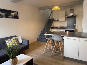a kitchen and living room with a couch and a table at Duplex 2 chambres Meximieux centre ville in Meximieux +14 photos