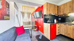 a small kitchen with red walls and a couch in a room at House on the Top in Patra +22 photos