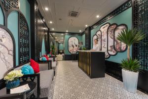 a lobby of a salon with chairs and a counter at Embrace Boutique Hanoi Hotel in Hanoi