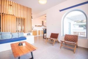 a living room with two chairs and a table at Casa Mare Melitsahas - Panoramic Sea View in Kalymnos +27 photos