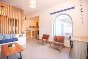 a kitchen and living room with a table and chairs at Casa Mare Melitsahas - Panoramic Sea View in Kalymnos