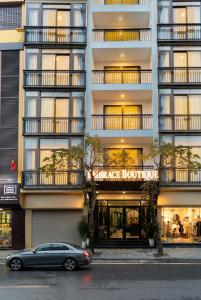 a car parked in front of a building at Embrace Boutique Hanoi Hotel in Hanoi