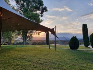 a tent in a field with a sunset in the background at Villa privada de lujo Can Riera in Pujals dels Cavallers