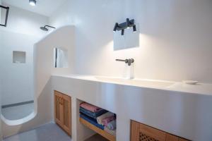 a bathroom with a sink and a mirror at Casa Mare Melitsahas - Panoramic Sea View in Kalymnos