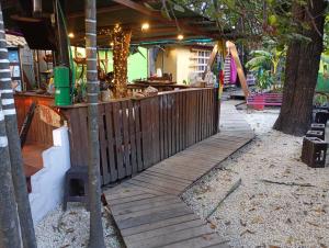 a wooden fence with a bar in a backyard at Nahimara Champeta Hostel in Cartagena de Indias