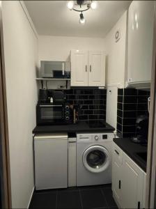a small kitchen with a washing machine in it at Studio - Chalon-sur-Saône in Chalon-sur-Saône