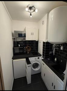 a small kitchen with a washing machine in it at Studio - Chalon-sur-Saône in Chalon-sur-Saône