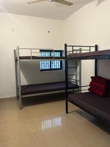 a room with three bunk beds in a room at The Maze House Anjuna! in Anjuna