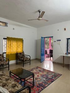 a living room with a couch and a table at The Maze House Anjuna! in Anjuna