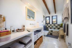 a bathroom with a sink and a toilet at Casa Puresa in Artá +3 photos