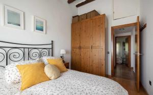 a bedroom with a bed and a wooden door at Casa Tossa – Piscina, Vistas Mar y A/C (6 pax) in Tossa de Mar +42 photos