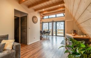 an open living room with a clock on the wall at Confortable Chalet Moderne in Anould