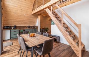 a dining room with a wooden table and a staircase at Confortable Chalet Moderne in Anould +30 photos