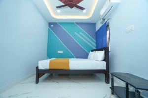 a bedroom with a bed with a painting on the wall at Ramnath Residency in Rāmeswaram +1 photo