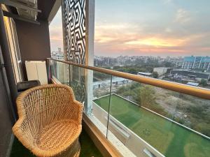 a balcony with a chair and a view of a city at Casa Dune in Pune