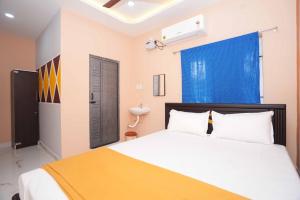 a bedroom with a large bed and a sink at Ramnath Residency in Rāmeswaram