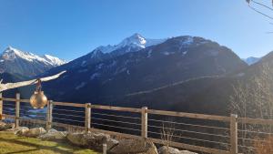 a fence with a view of a mountain at Haus am Stein in Finkenberg