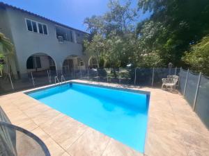 a swimming pool in front of a house at POUSADA PARAISO da BARRA DA TIJUCA in Rio de Janeiro