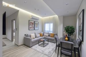 a living room with a couch and a table at Flexistay Sheikh Zayed in Sheikh Zayed +146 photos