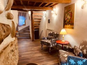 a living room with chairs and a table and stairs at La Torretta in Laterina