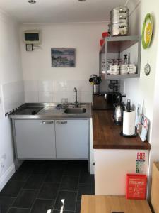 a kitchen with a sink and a counter top at Pier Cottage at Kames in Kames