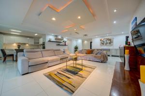 a living room with a couch and a table at Unique - Spacious 3BR Premium Flat in Is-Swieqi