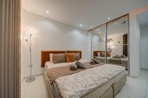 a bedroom with a large bed in a room at Unique - Spacious 3BR Premium Flat in Is-Swieqi