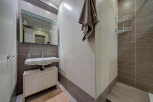 a bathroom with a sink and a shower at Unique - Spacious 3BR Premium Flat in Is-Swieqi +36 photos
