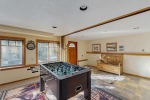 a living room with a foosball table in the middle at Ponderosa Cabin in Bend