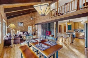 a living room with a dining table and a kitchen at Ponderosa Cabin in Bend