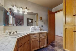 a bathroom with a sink and a large mirror at Ponderosa Cabin in Bend +14 photos