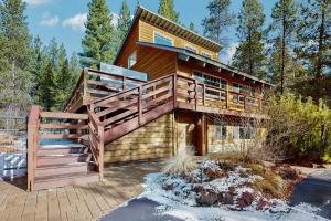 a large wooden house with a large deck at Ponderosa Cabin in Bend