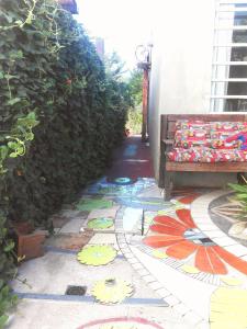 a walkway with a bench and colorful tile floors at Habitación en Casa Museo in Villa Garibaldi