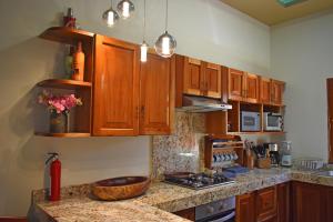 a kitchen with wooden cabinets and a counter top at VILLA UNAHANA in Valladolid