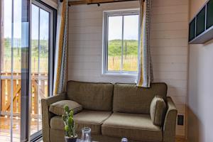 a living room with a couch and a window at Les Chalets du Lac - Amnéville Cité des Loisirs Galaxie in Amnéville +64 photos