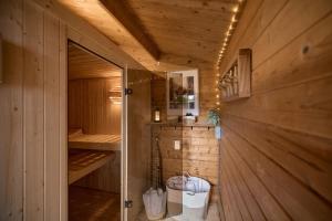 a wooden cabin with a sauna with a glass door at CATO Ferienhaus in Kiefersfelden