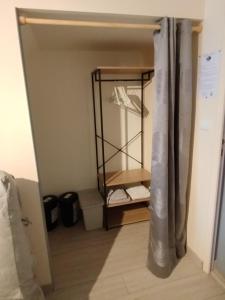 a room with a closet with a mirror and a shelf at L'Epinette in Torchefelon +22 photos