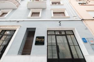 a white building with a sign on it at Chic & Comfortable Apartment, Private Terrace in Valencia