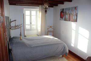 a bedroom with a bed in a room with a window at Oasis de Compostelle in Lauzerte +21 photos