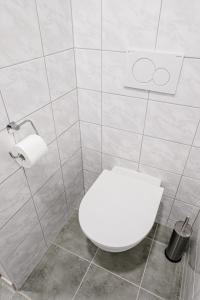 a bathroom with a white toilet and a roll of toilet paper at Ubytování Smějsík in Blatnice