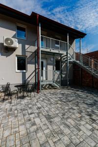 a patio with chairs and a building with a balcony at Ubytování Smějsík in Blatnice