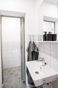 a white bathroom with a sink and a mirror at Ubytování Smějsík in Blatnice