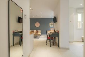 a dining room and living room with a table and chairs at Chic & Comfortable Apartment, Private Terrace in Valencia