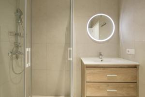 a bathroom with a sink and a shower with a mirror at Chic & Comfortable Apartment, Private Terrace in Valencia +26 photos