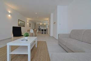 a living room with a couch and a table at Swieqi Malaika New Apt 4 in Is-Swieqi