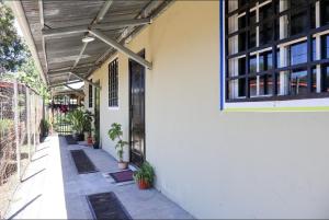 a building with a porch with potted plants on it at Hospedaje Ofe,S #3 in Santiago