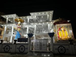 a large white building with a picture of a monk at Shri radha kripalu dham in Vrindāvan