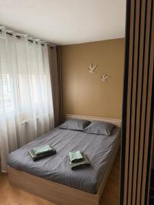 a bedroom with a bed with two trays on it at Studio - Chalon-sur-Saône in Chalon-sur-Saône