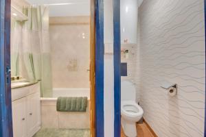 a bathroom with a toilet and a sink and a shower at L'Échappée Belle de Houlgate 2 personnes in Houlgate +15 photos